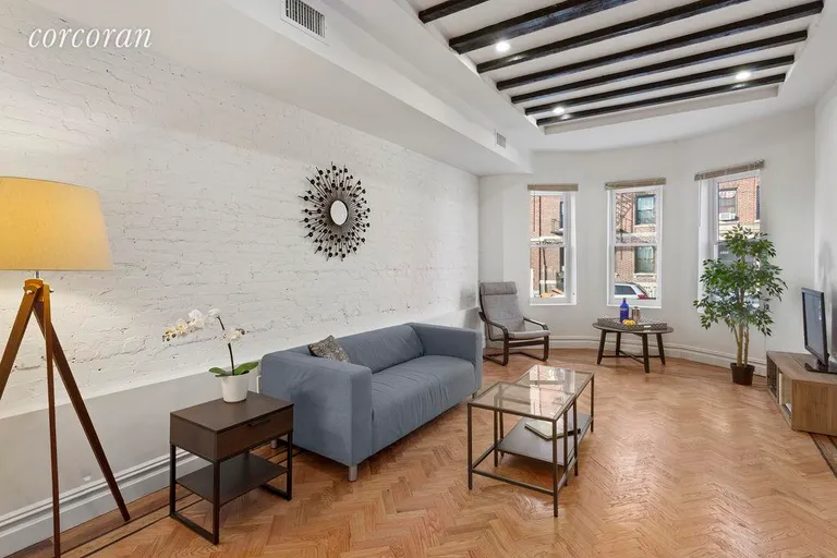 New York City Real Estate | View 1376 Sterling Place | Living room with beamed ceiling | View 3