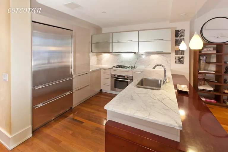 New York City Real Estate | View 163 West 18th Street, 3A | Chef's kitchen and cherry wood breakfast bar | View 2