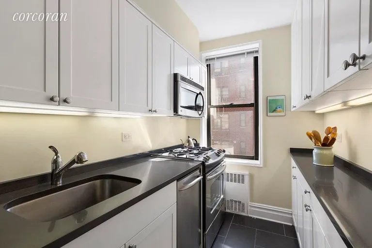 New York City Real Estate | View 30 East 9th Street, 4K | Windowed Kitchen with Pass Through to Living Room | View 5