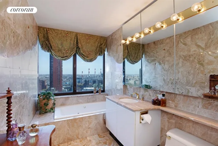New York City Real Estate | View 422 East 72nd Street, 30A | Master bathroom has separate shower and spa tub | View 9