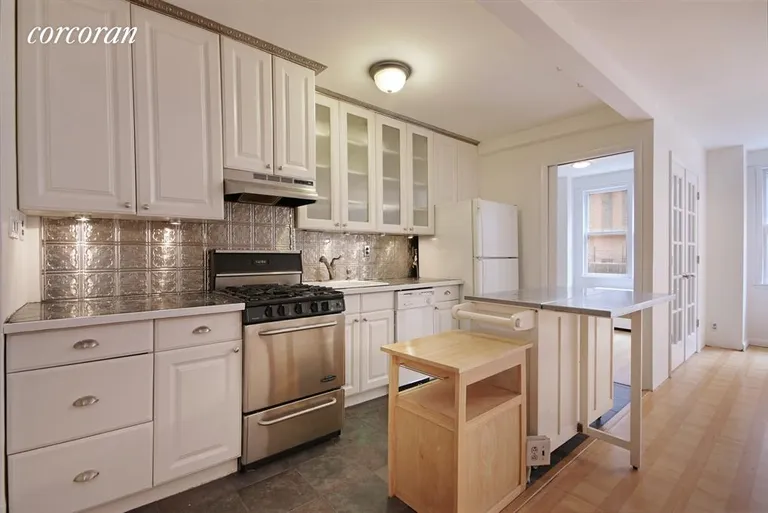 New York City Real Estate | View 201 East 36th Street, 5F | Open, Updated Kitchen with island / breakfast bar | View 3