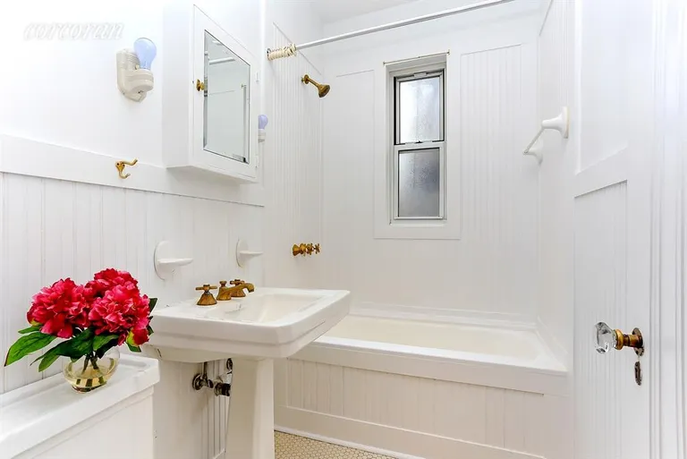 New York City Real Estate | View 27 Commerce Street, 5A | Bathroom with wainscoting details | View 4