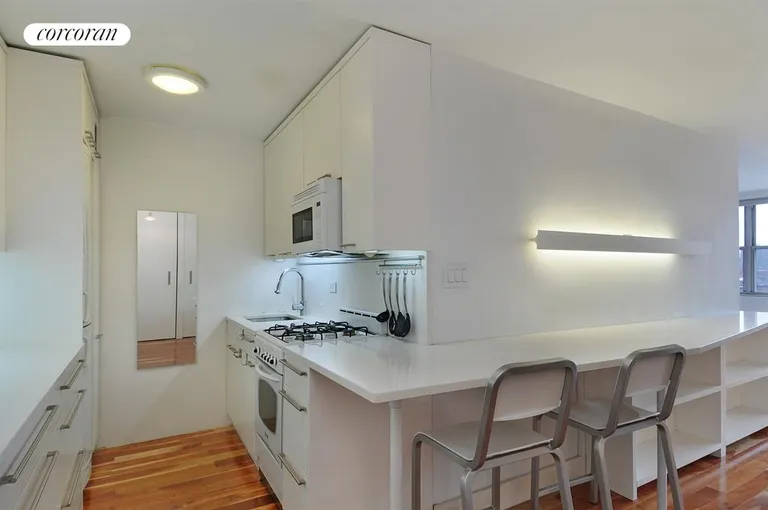 New York City Real Estate | View 333 East 14th Street, 10G | Modern renovated kitchen with breakfast bar | View 3