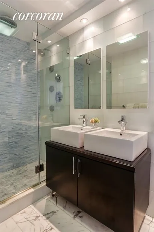 New York City Real Estate | View 115 East 87th Street, 38F | Master Bathroom with Double Sink + marble & glass  | View 7