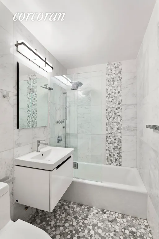 New York City Real Estate | View 2 Charlton Street, 7K | Beautifully renovated bath w/ pebble accent tiles. | View 3