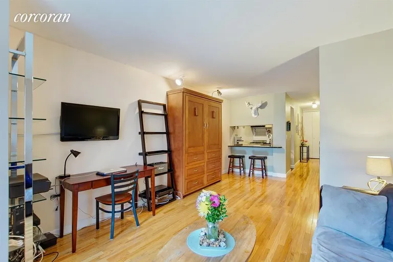 New York City Real Estate | View 350 West 50th Street, 3HH | Living Room with Murphy bed(wooden cabinet shown) | View 2