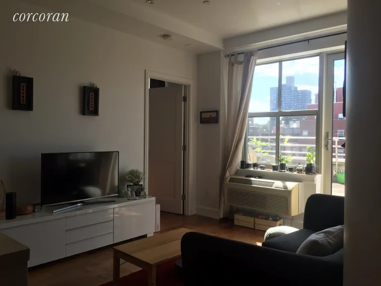 New York City Real Estate | View 2255 Adam Clayton Powell Boulevard, PH-A | The living room looks out over the terrace. | View 3