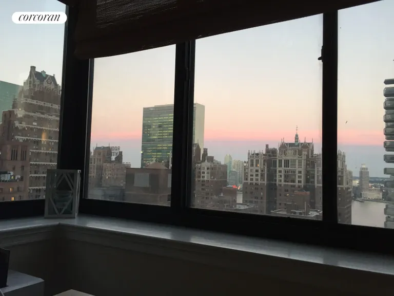 New York City Real Estate | View 250 East 40th Street, 26E | Beautiful evening view & East River in Living Room | View 8