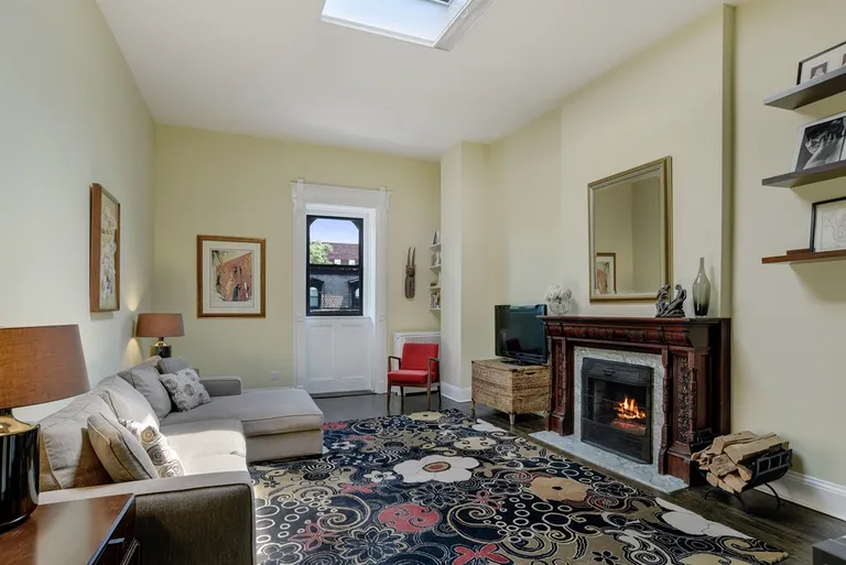 New York City Real Estate | View 44 8th Avenue, 5 | Living Room with wood-burning fireplace & skylight | View 3