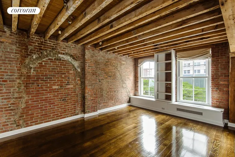 New York City Real Estate | View 62 Beach Street, 4E | Master Bedroom with Brick Wall and Beamed Ceilings | View 4
