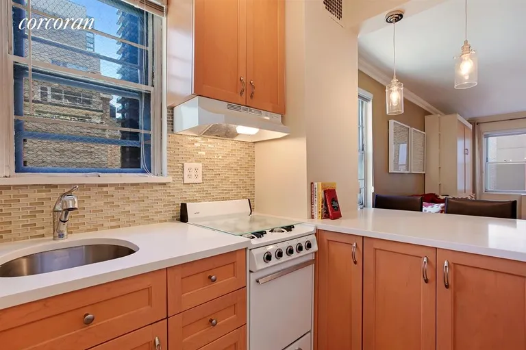 New York City Real Estate | View 310 East 49th Street, 9C | Pass-through Kitchen with Breakfast Bar | View 2