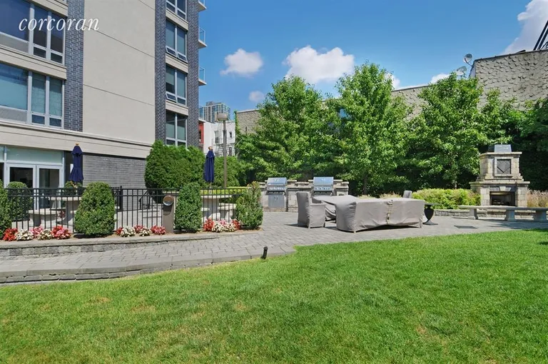 New York City Real Estate | View 5-49 Borden Avenue, 10A | Residents Garden with fireplace and barbecues | View 4