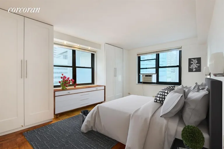 New York City Real Estate | View 135 East 54th Street, 6B | Corner master bedroom (virtually staged) | View 2