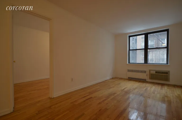 New York City Real Estate | View 222 East 75th Street, 1E | Living Room and Bedroom entrance | View 2