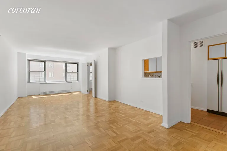 New York City Real Estate | View 525 East 86th Street, 8G | Living room and pass through kitchen. | View 9