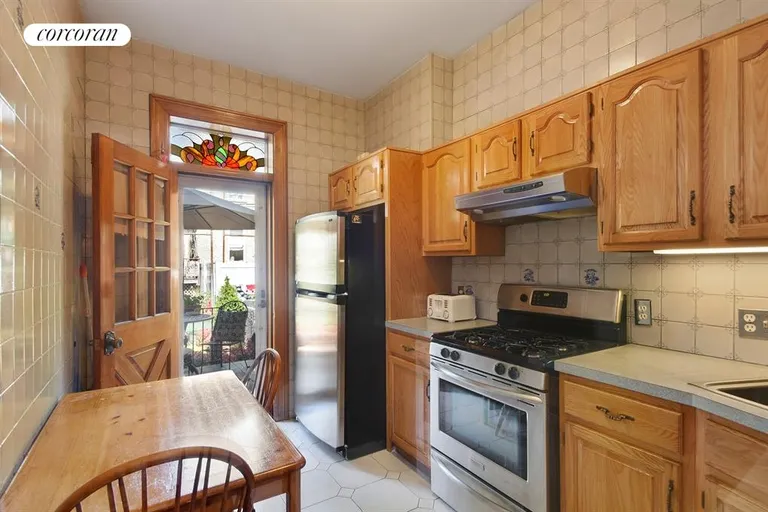 New York City Real Estate | View 561 74th Street | Good-Sized Kitchen Opens onto Rear Patio and Yard | View 4