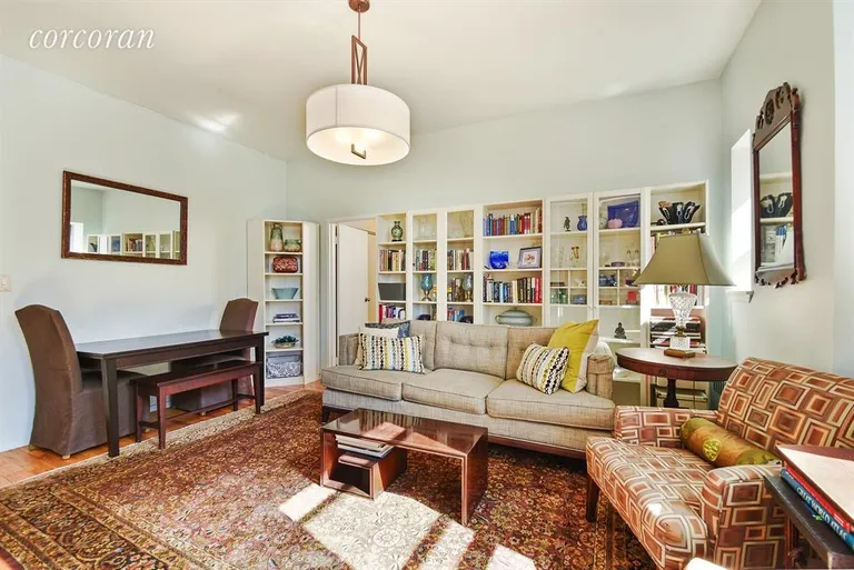 New York City Real Estate | View 689 Fort Washington Avenue, PH1 | Living Room with the windows behind | View 3