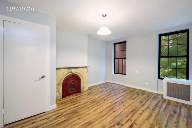 New York City Real Estate | View 379 Gates Avenue | Bedroom with original fireplace and garden views | View 12