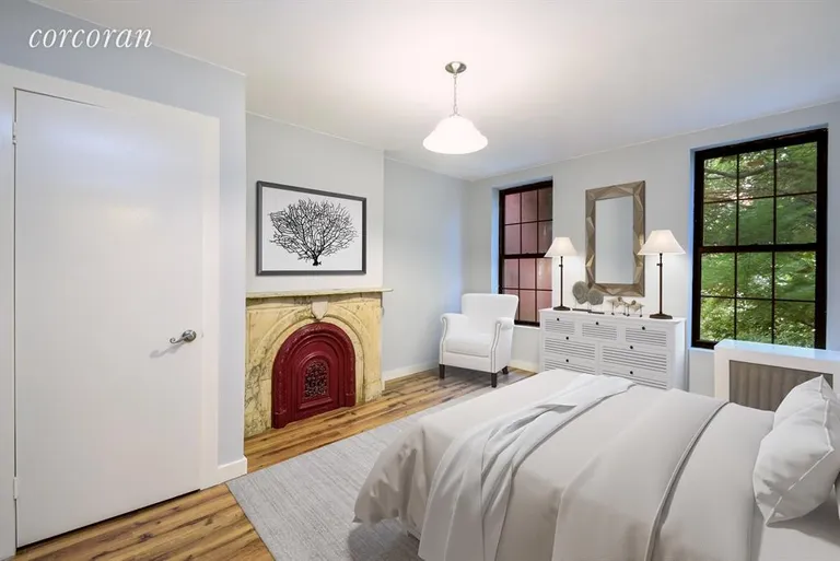 New York City Real Estate | View 379 Gates Avenue | Bedroom with original fireplace and garden views | View 4