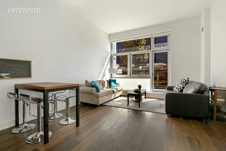 New York City Real Estate | View 390 Lorimer Street, 1A | Spacious and bright living area leading to patio | View 2