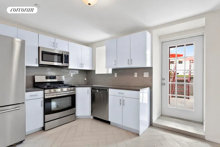 New York City Real Estate | View 69 Maujer Street, 1 FL | Windowed chef's kitchen with new appliances | View 4