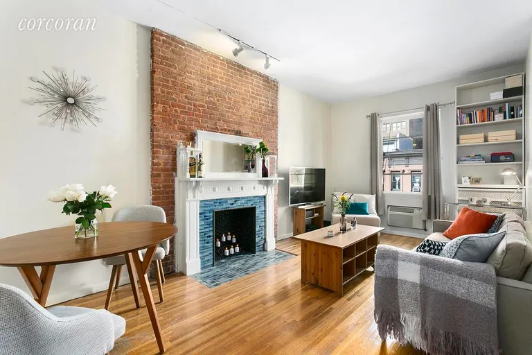 New York City Real Estate | View 46 West 71st Street, 4A | Bright living room with decorative fireplace | View 2