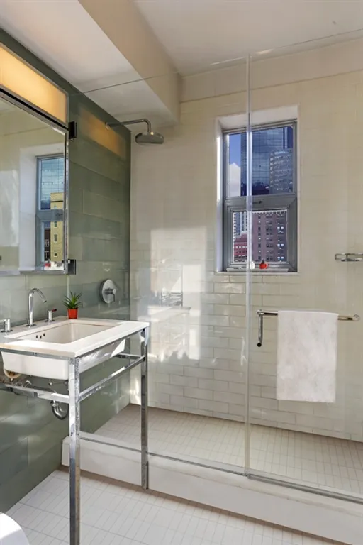 New York City Real Estate | View 211 East 51st Street, 10G | Expertly-designed bathroom with large shower | View 7