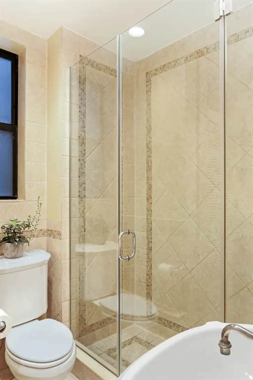 New York City Real Estate | View 221 West 82nd Street, 6AB | Mint renovated bathroom with glass shower | View 7