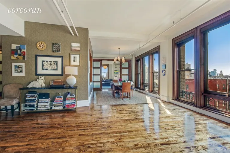 New York City Real Estate | View 684 Broadway, 9E | Living Area with Art Walls and Wall of Windows | View 3