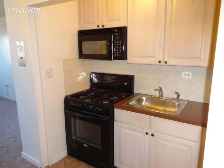 New York City Real Estate | View 191 Willoughby Street, 11F | Full size stove and upper microwave | View 5