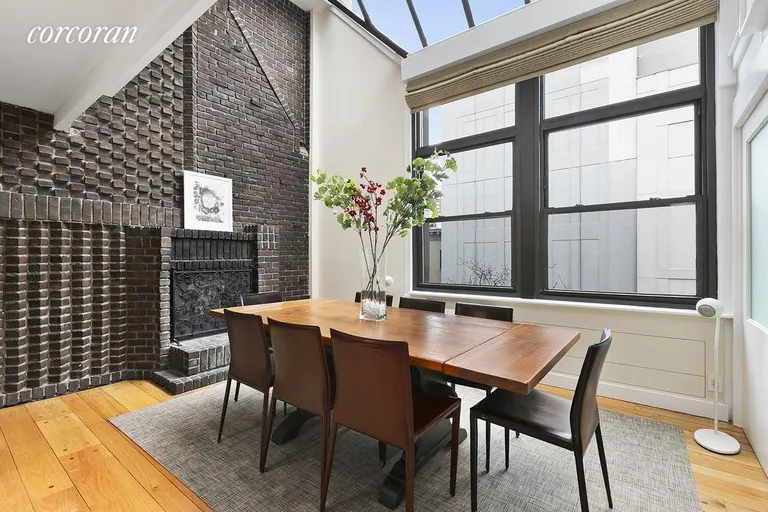 New York City Real Estate | View 260 West 22nd Street, PH4 | Dining Room with WB Fireplace & Cathedral Ceiling | View 4