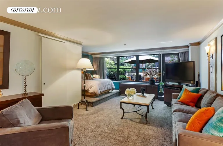 New York City Real Estate | View 225 East 57th Street, 1Q | Living Room looking onto Private Terrace | View 3
