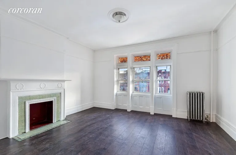 New York City Real Estate | View 911 Sterling Place | South Facing Family Room w/ Working Fireplace | View 4