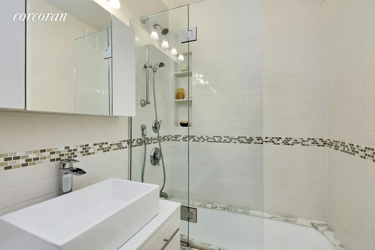 New York City Real Estate | View 400 East 56th Street, 20C | Modern Bathroom with Marble Encased Bathtub | View 6