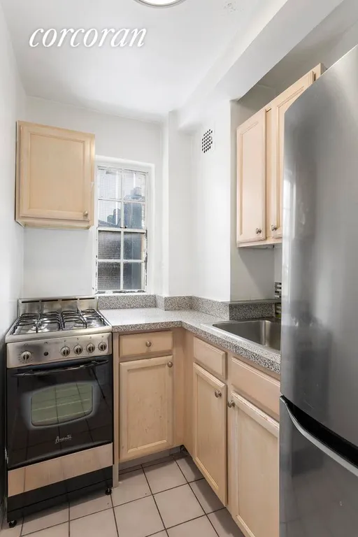 New York City Real Estate | View 310 West 56th Street, 10G | Stainless steel appliance plus a window! | View 4