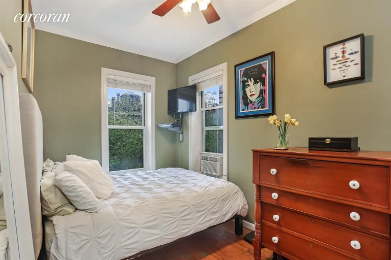 New York City Real Estate | View 509 East 83rd Street, 5R | Bedroom looks out onto tree tops | View 4