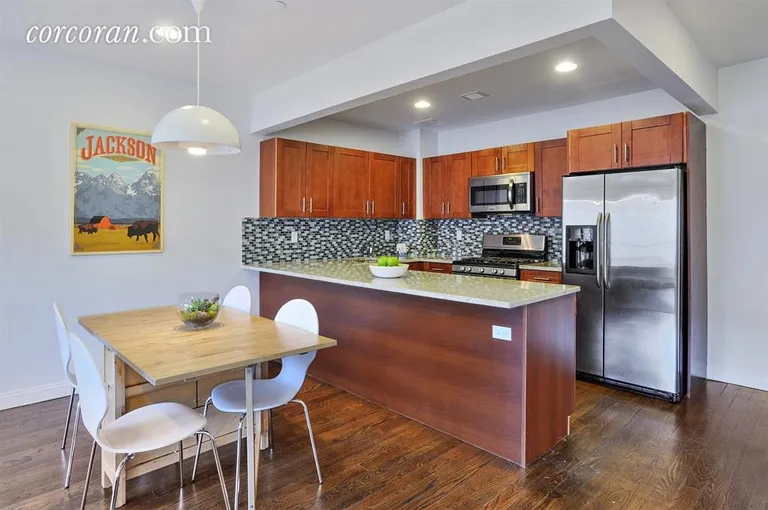 New York City Real Estate | View 1138 Ocean Avenue, 5E | Modern kitchen with granite top wrap around island | View 2