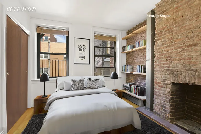 New York City Real Estate | View 243 Mulberry Street, 4R | Queen-sized bedroom with decorative fireplace | View 2