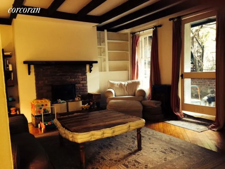 New York City Real Estate | View 310 Warren Street, 1 | Living Room with Gas Fireplace | View 4