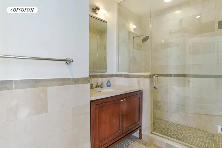 New York City Real Estate | View 1 Hanson Place, 24B | Frameless Shower with Mosiac Stone Floors | View 4