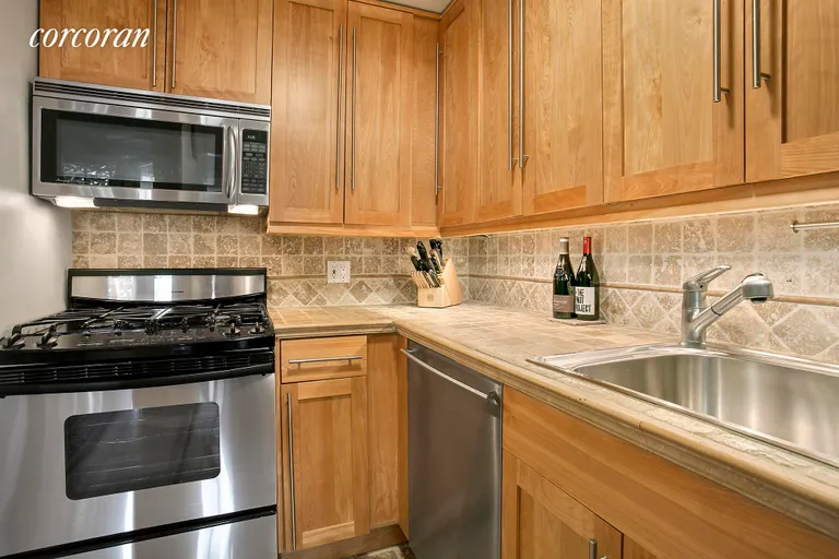 New York City Real Estate | View 67 East 11th Street, 612 | Renovated kitchen, Noce Travertine counters | View 4