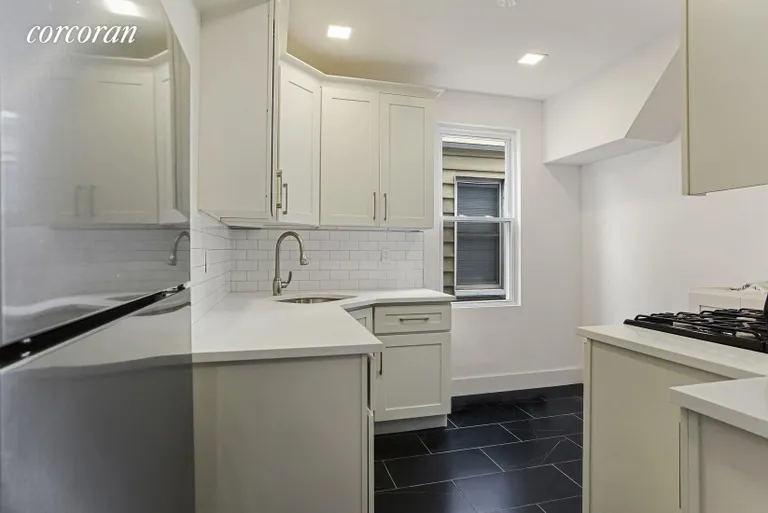 New York City Real Estate | View 707 Ditmas Avenue | Windowed White Shaker Kitchen w/ Whirlpool Applian | View 4