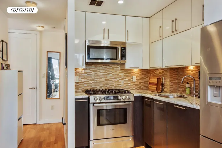 New York City Real Estate | View 500 4th Avenue, 8H | Open kitchen with stainless steel appliances | View 2