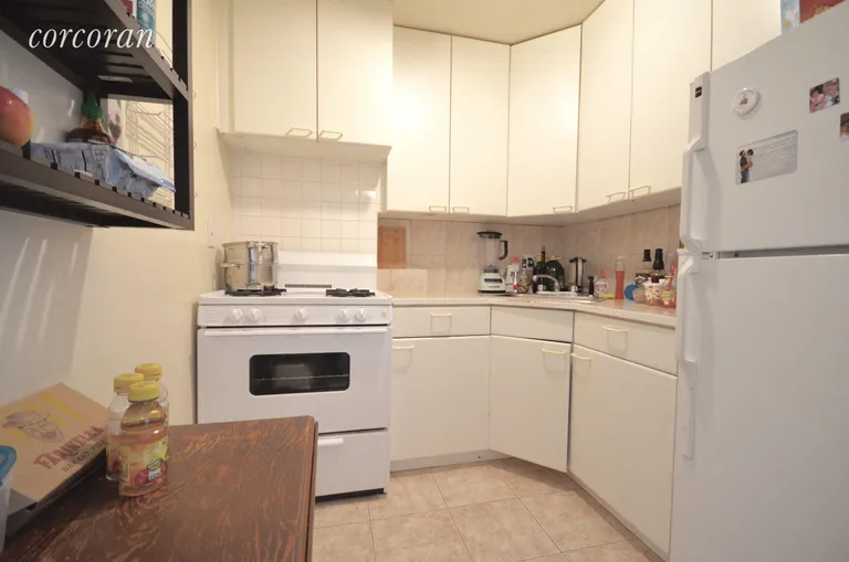 New York City Real Estate | View 222 East 75th Street, 2B | Kitchen with gas stove and lots of cabinets | View 4