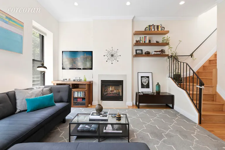 New York City Real Estate | View 33 Saint Marks Place, 3 | Living area with gas fireplace | View 2