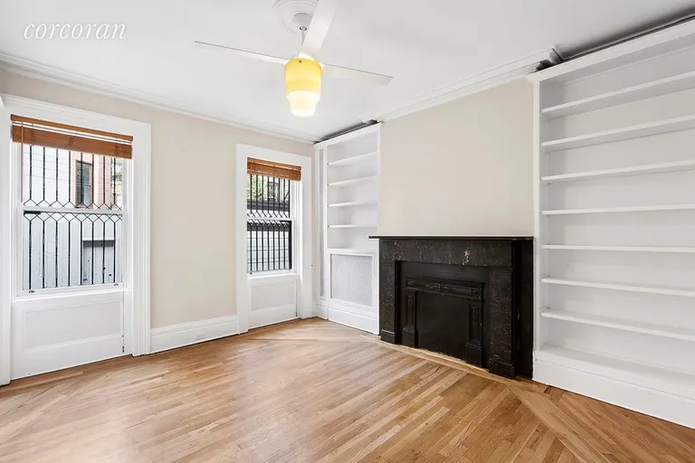 New York City Real Estate | View 6 Verandah Place | Built-ins surround Wood Burning Fire Place | View 4