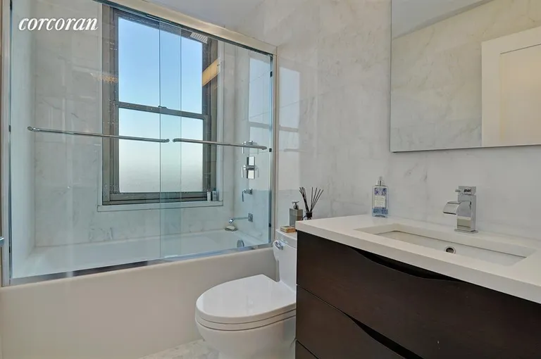 New York City Real Estate | View 301 East 79th Street, 36H | Marble Windowed Bathroom | View 6