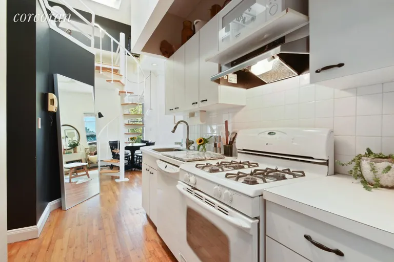 New York City Real Estate | View 307 72nd Street, 4D | Tucked away kitchen with breakfast bar | View 3