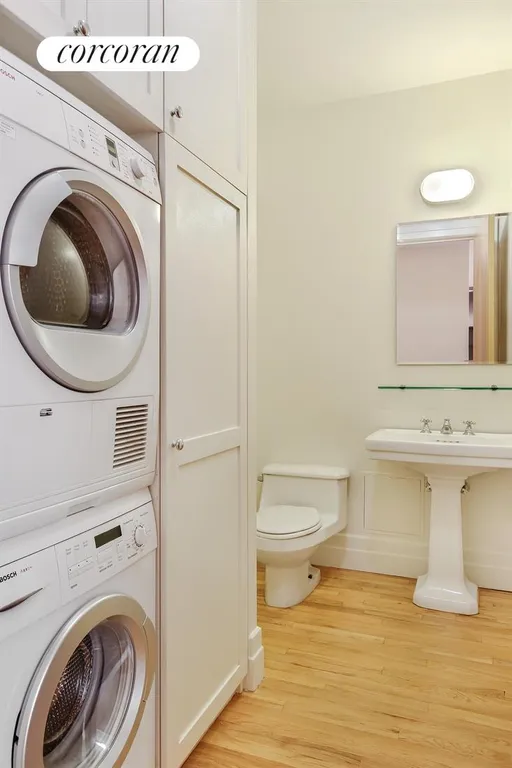 New York City Real Estate | View 1 Main Street, 3F | Half bath and laundry with built-in storage | View 6