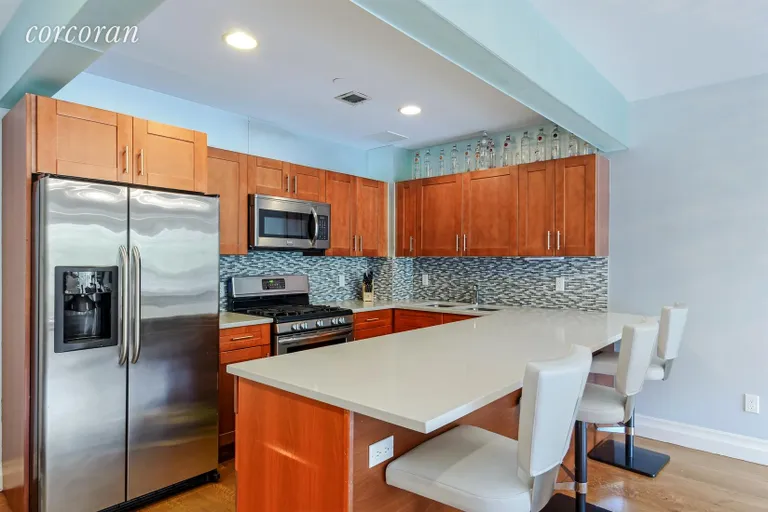 New York City Real Estate | View 1138 Ocean Avenue, 4D | Custom frosted glass tile framing kitchen like art | View 3